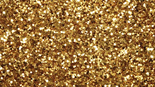Gold glitter texture fills frame with dense reflective sparkle
