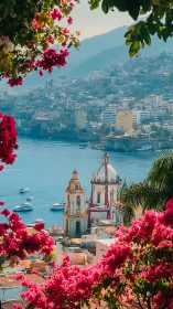 Coastal hillside city with church domes and pink flowers.