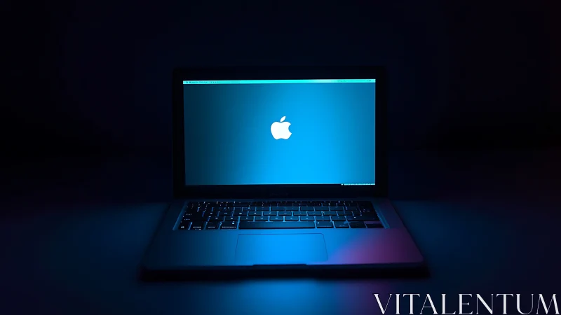 Low-key laptop product shot with cool neon rim lighting.