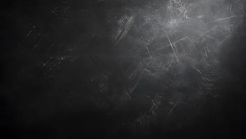 Scratched dark surface presents dispersed linear abrasions