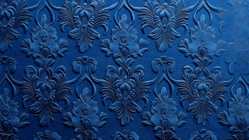 Embossed blue damask floral pattern on textured surface.