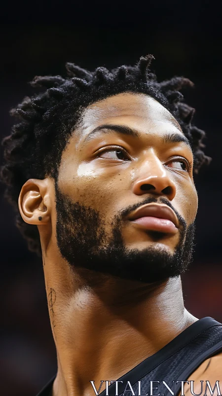 Courtside gaze of a focused baller under arena lights.