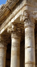 Sunburned Corinthian columns guarding a lion-crowned temple.