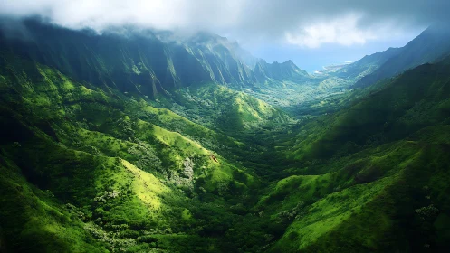 Mountain valley landscape extends toward distant coastline