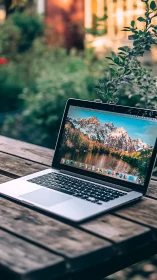 Laptop daydreaming on a rustic garden table at golden hour.