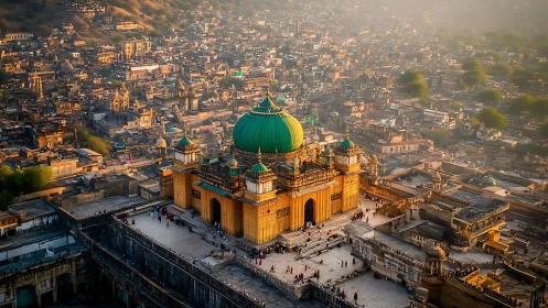 Golden domed mosque crowns dense hillside cityscape.