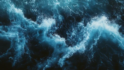 Roiling teal ocean waves in dramatic overhead motion study.