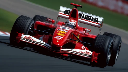 Red Formula One racing car on asphalt circuit cornering fast.