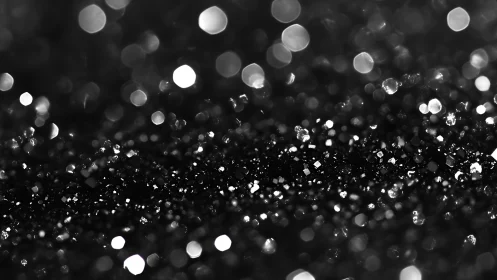 Macro bokeh analysis of crystalline black glitter field.