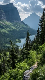 Mountain lake valley framed by alpine trail and steep cliffs