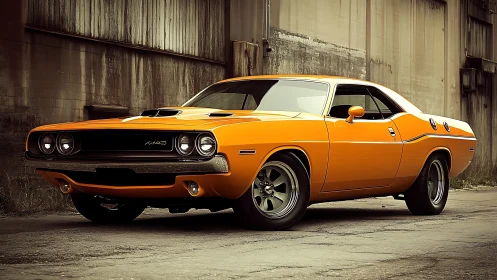 Orange classic muscle car is parked beside worn industrial wall