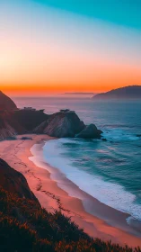 Dramatic cliffside beach coastline under vivid sunset sky.