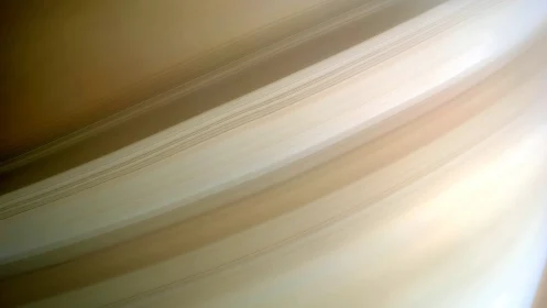 Oblique close-up view of Saturn&rsquo;s rings in soft radial gradient