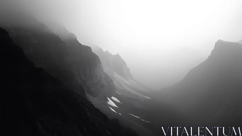 Fog-draped mountain chasm whispers in grayscale silence