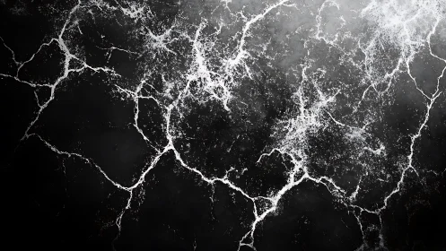 Abstract black marble texture with white cracks in dramatic style.
