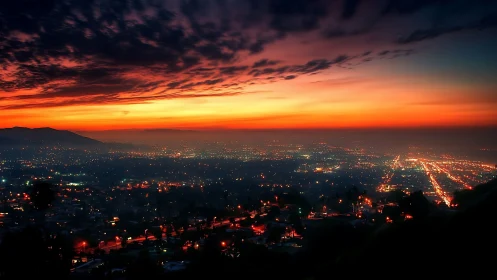 City lights glow beneath a vivid, slowly darkening sunset sky