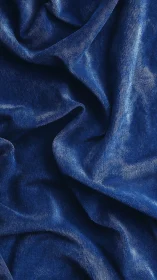 Deep blue textile folds reveal fine weave and directional sheen