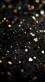 Golden shards glow across dark glittering surface