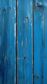 Weathered blue wooden planks with vertical grain detail.