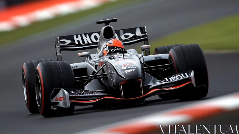 Black Formula race car attacking fast circuit corner at speed.