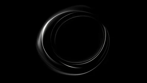Glowing circular light trails on black abstract background.