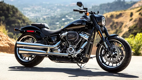 Black cruiser motorcycle parked on mountain roadside in sun.