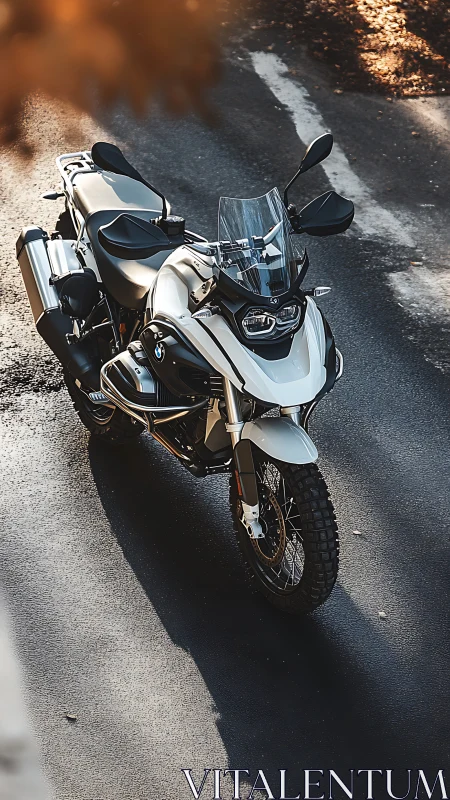 Adventure touring motorcycle in warm directional sunlight.