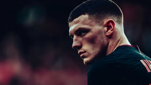 Focused football player captured in dramatic sideline portrait.