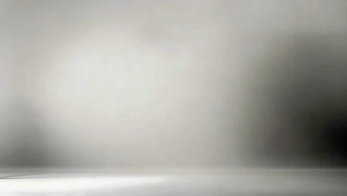 Soft gradient gray studio backdrop forms empty display space