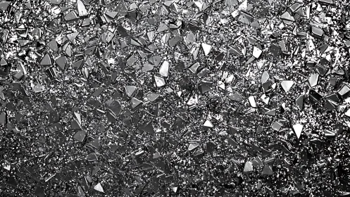 Close-up of Shattered Glass Fragments in Abstract Monochrome Style.