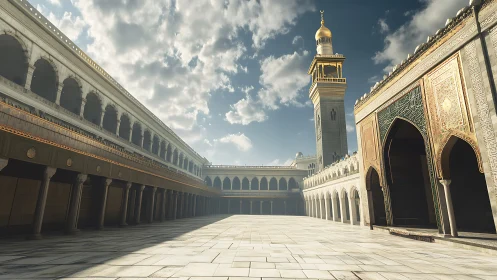 Sunlit Islamic courtyard with ornate minaret and arcades.
