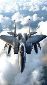 Modern fighter jet flying above dense white cloud layer.