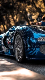 Blue supercar close-up with chrome wheel reflections.