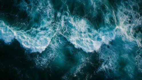 Rolling teal waves dance across a foaming ocean surface