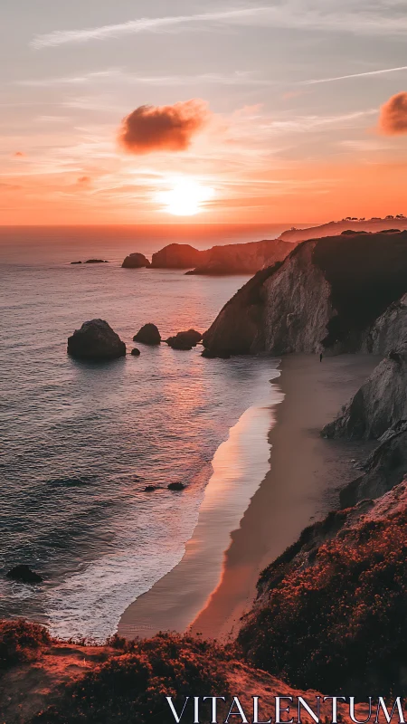 Coastal cliffs and shoreline at sunset under orange sky.