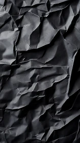 Wrinkled midnight folds quietly sculpt a shadowed terrain