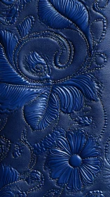 Midnight blue floral leather with swirling embossed blooms.
