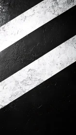 Diagonal black white stripes cut rough textured surface.