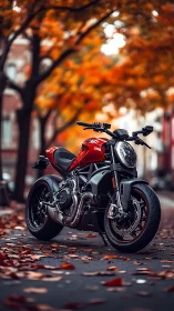 Red sport motorcycle stands on city street with autumn trees