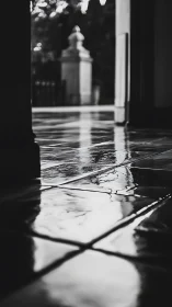 Wet tiled corridor reflects outdoor stone balustrade view