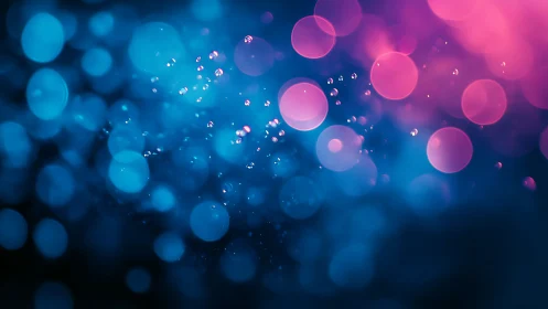Neon blue and magenta bokeh spheres in abstract depth field.