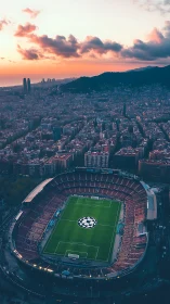 Sunset aerial reveals packed football stadium in city grid.