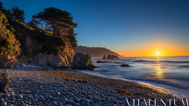 Coastal cliff sunrise over pebble shoreline in warm light.