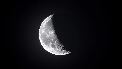 Crescent moon rendered in high-contrast astrophotographic detail