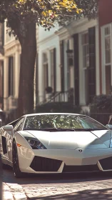 Low-slung white supercar on sunlit cobblestone street façade.