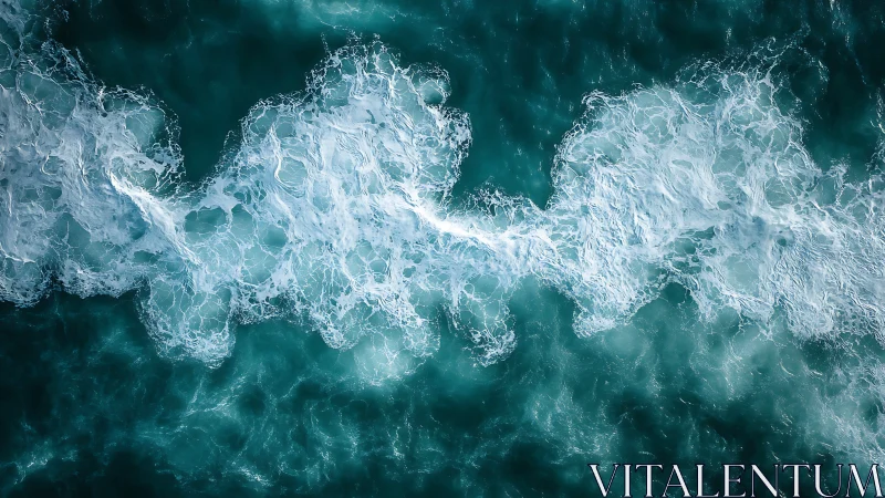 Seafoam ribbons drifting over deep teal rolling water.