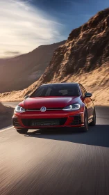 Red sport hatchback cuts through sunlit canyon highway