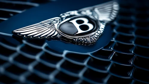 Macro close up luxury car winged emblem on dark mesh grille