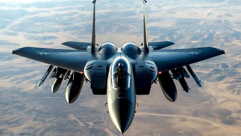 Modern fighter jet in level flight over desert terrain.