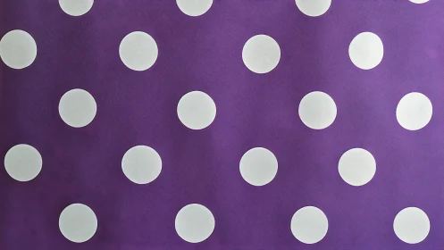 White polka dots evenly spaced on textured purple background.